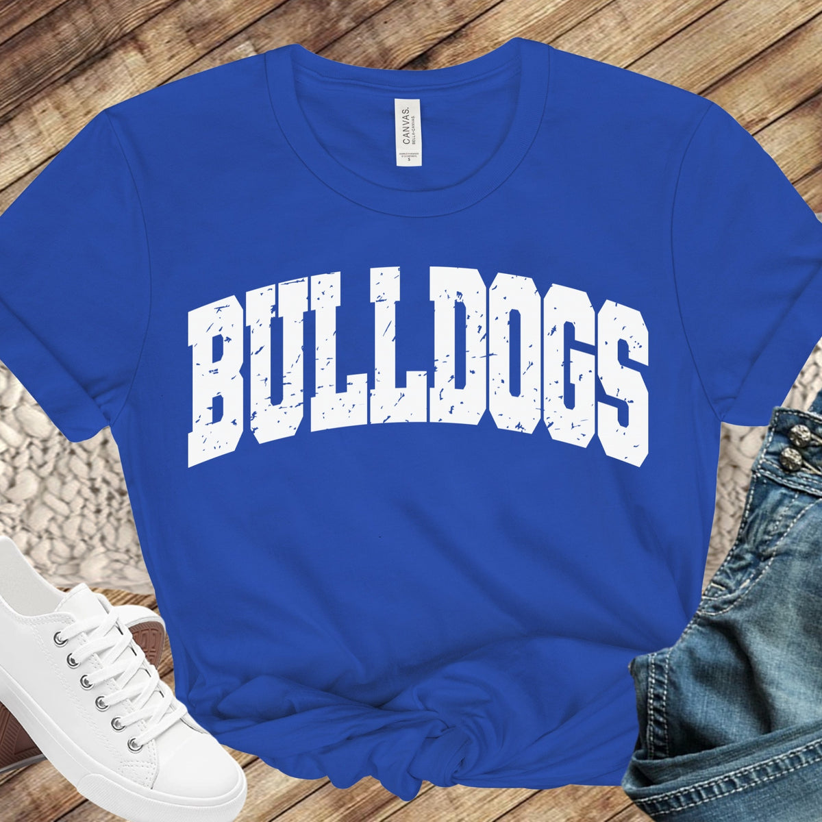 JWP Bulldogs White Distressed on royal blue T-shirt flat lay