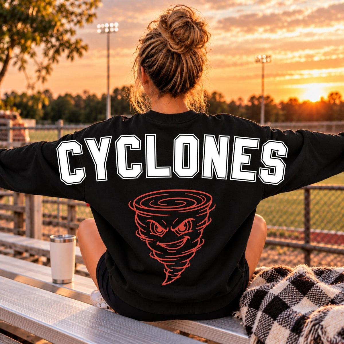 White outline Cyclones lettering with red tornado mascot on black sweatshirt